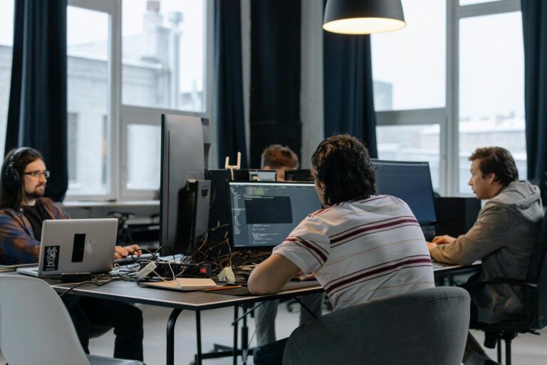 Dust’s Enterprise AI Platform Is Chipping Away at Glean’s Momentum Enterprise tech team collaborating around a computer screen in a modern office