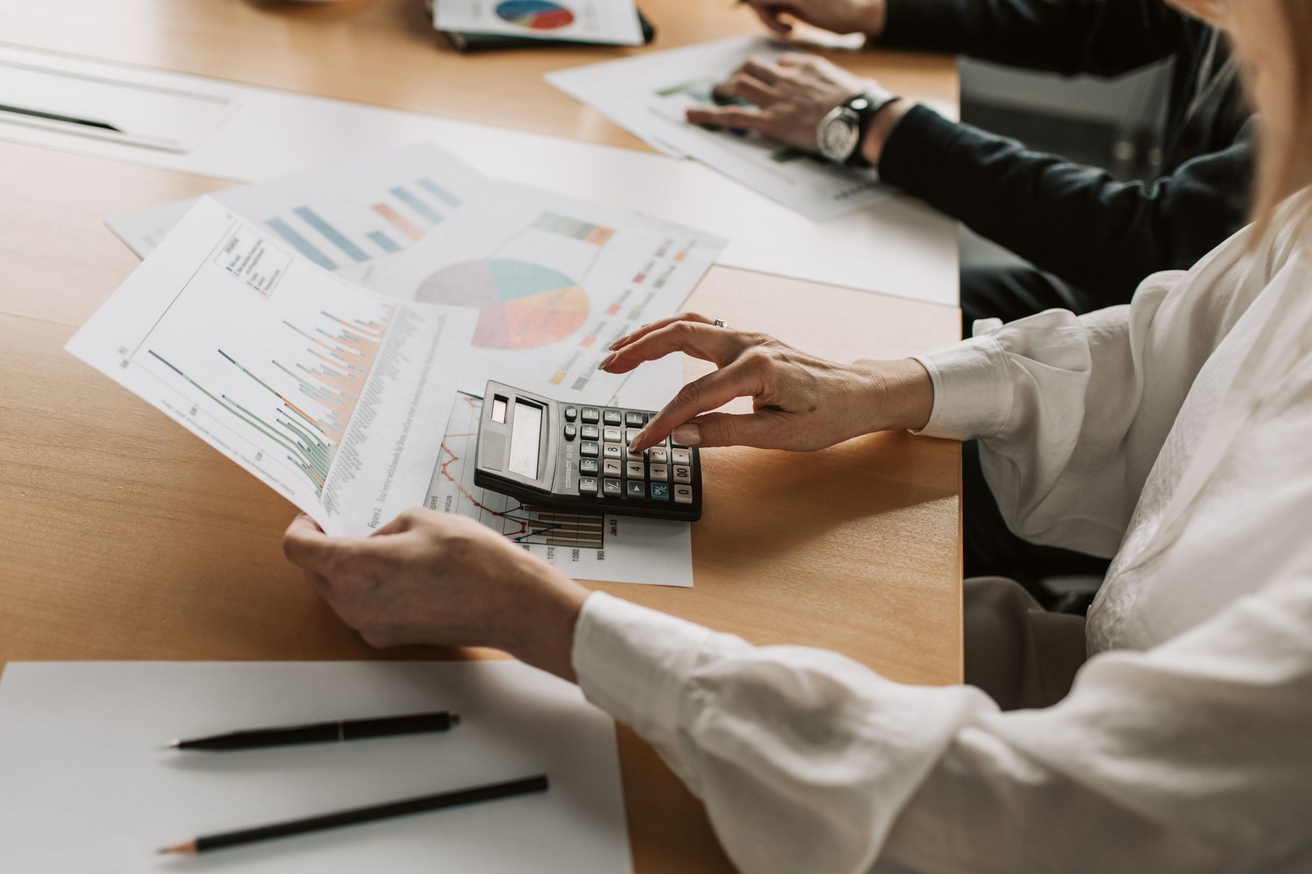 Business team reviewing financial documents and payment workflows in a corporate office