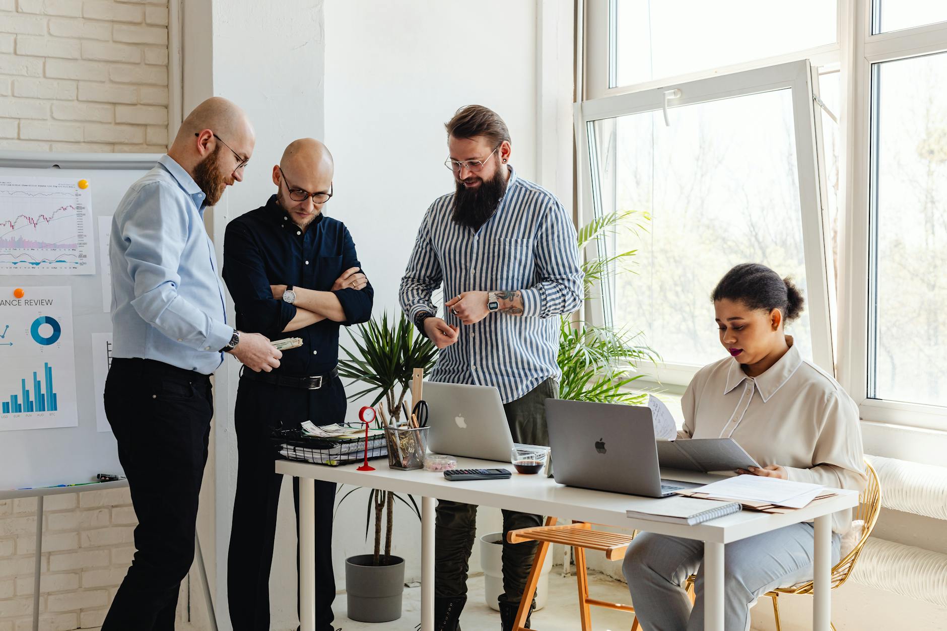 Small startup team collaborating on a product in a modern office