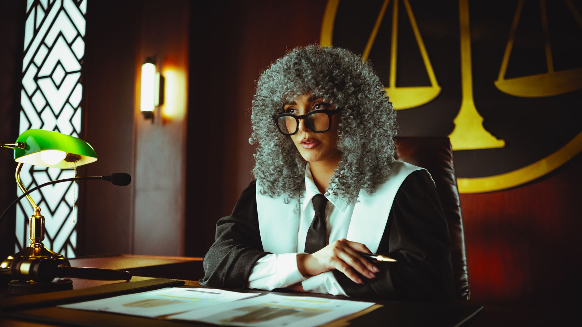 Attorney working at a modern law office with multiple monitors displaying documents