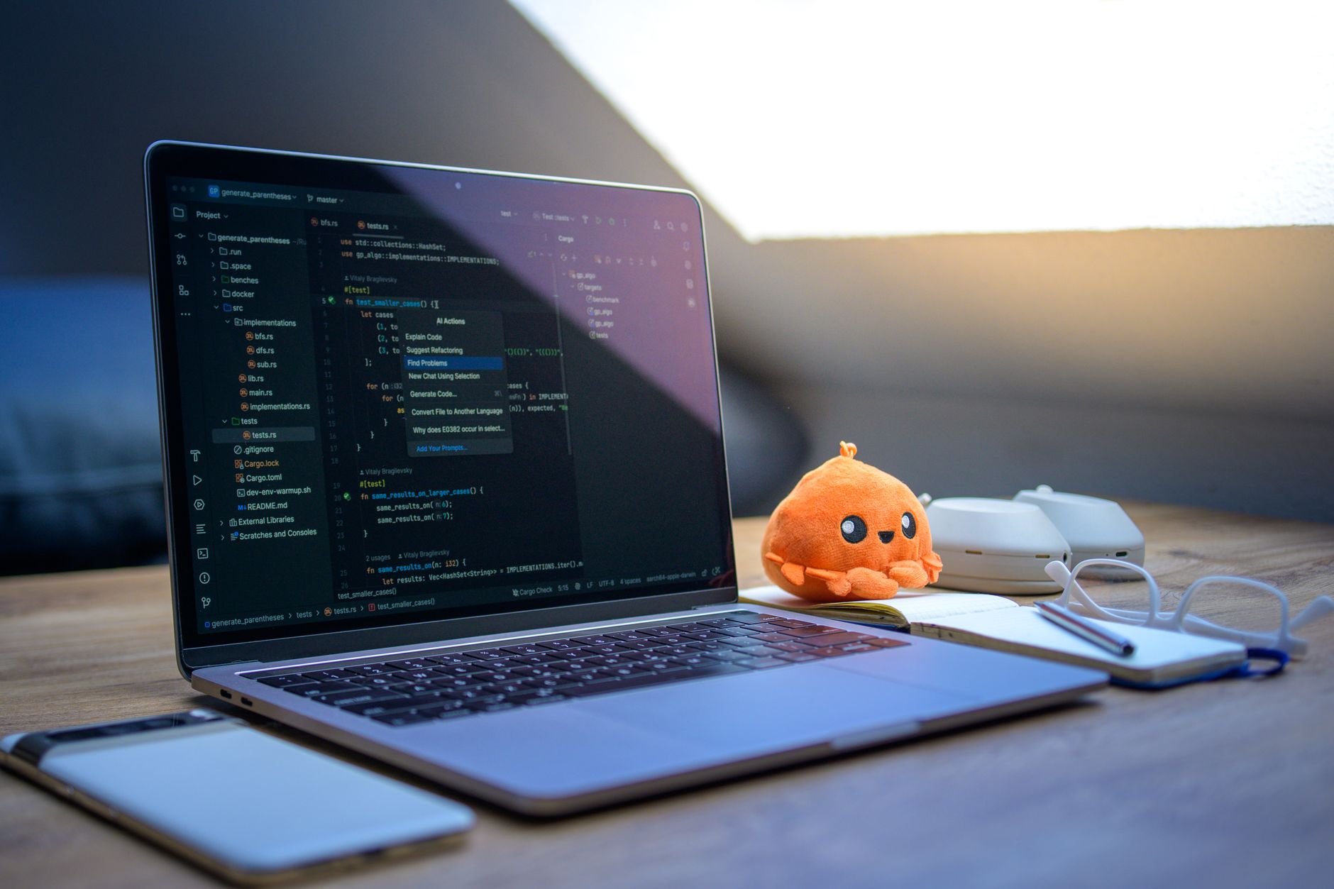 Developer working at a dual-monitor setup with code and financial dashboard visible