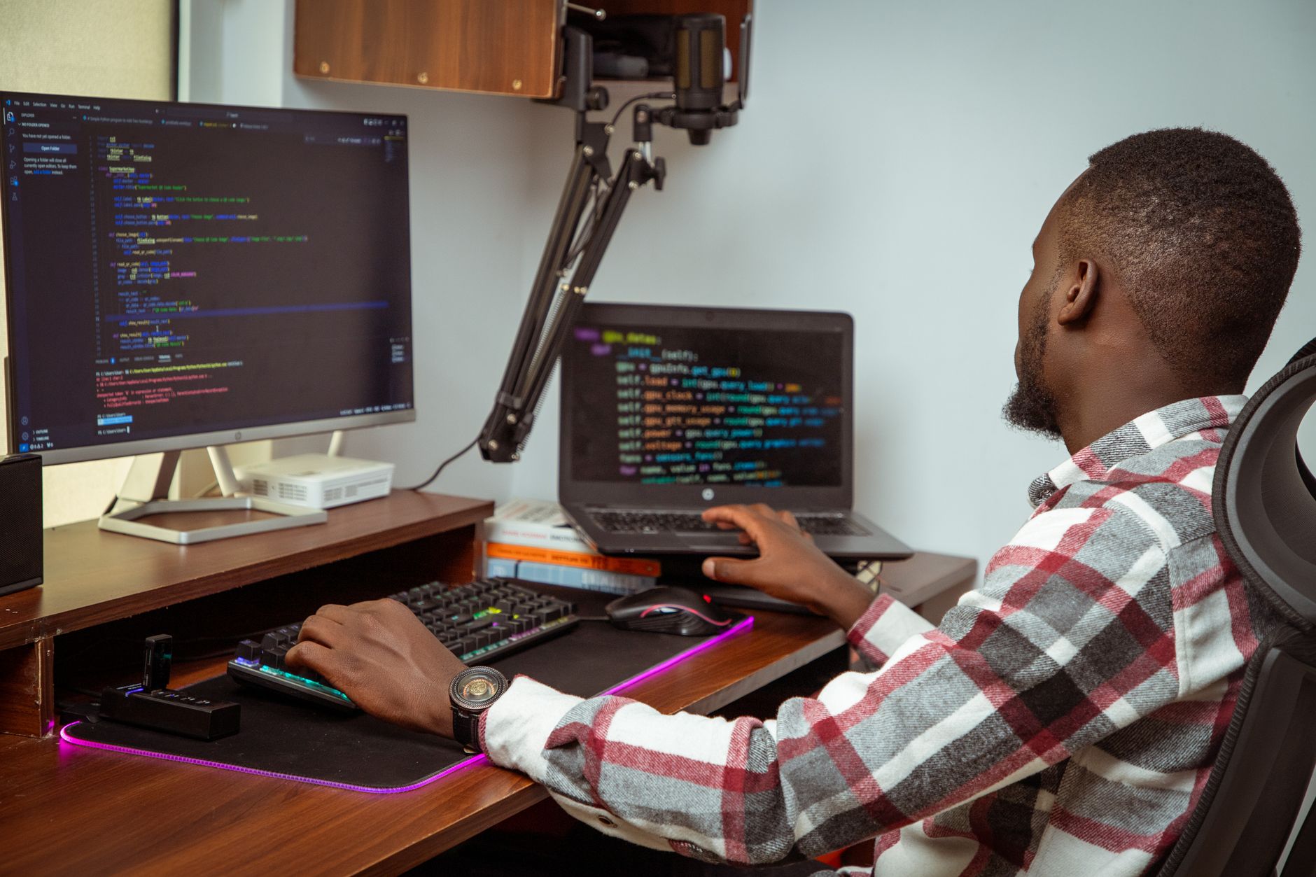 Solo developer reviewing code on a laptop screen in a minimal workspace