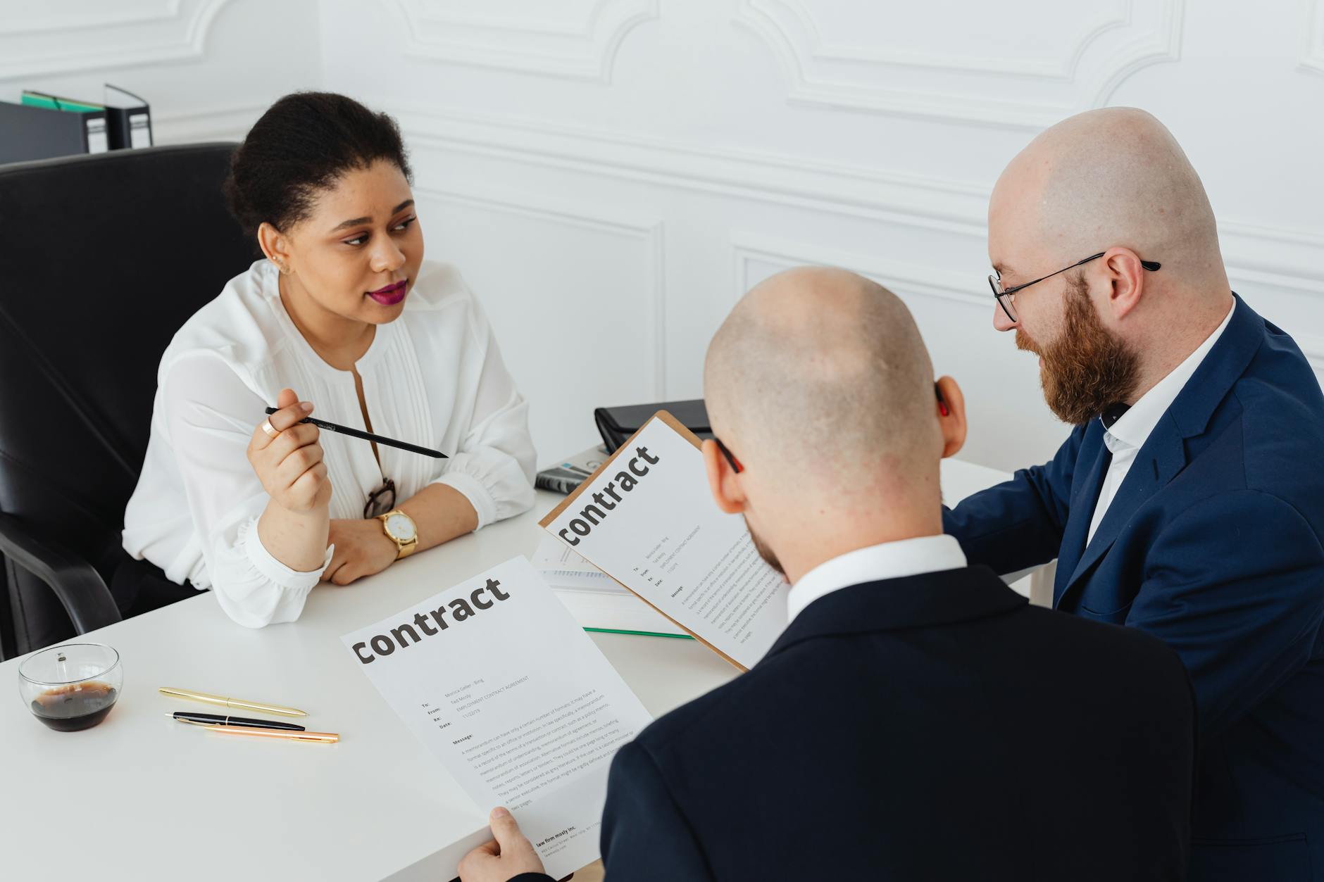 Two professionals reviewing and signing a business contract representing enterprise software procurement