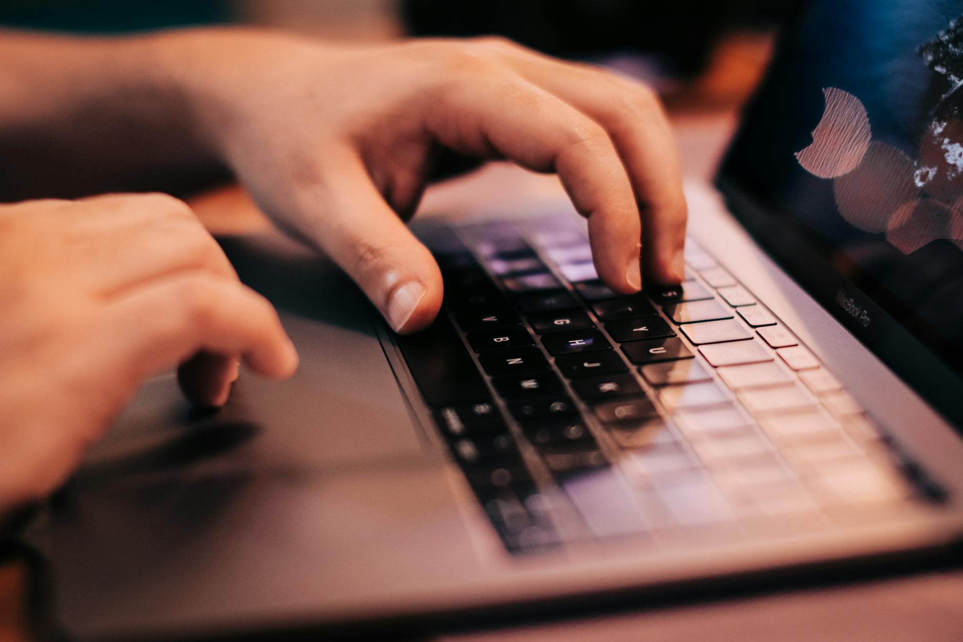 A person typing on a laptop, building a digital project independently