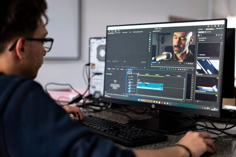 Descript’s Video Editing Push Is Crowding CapCut’s Creator Base A person editing video footage on a desktop computer with a timeline interface visible on screen