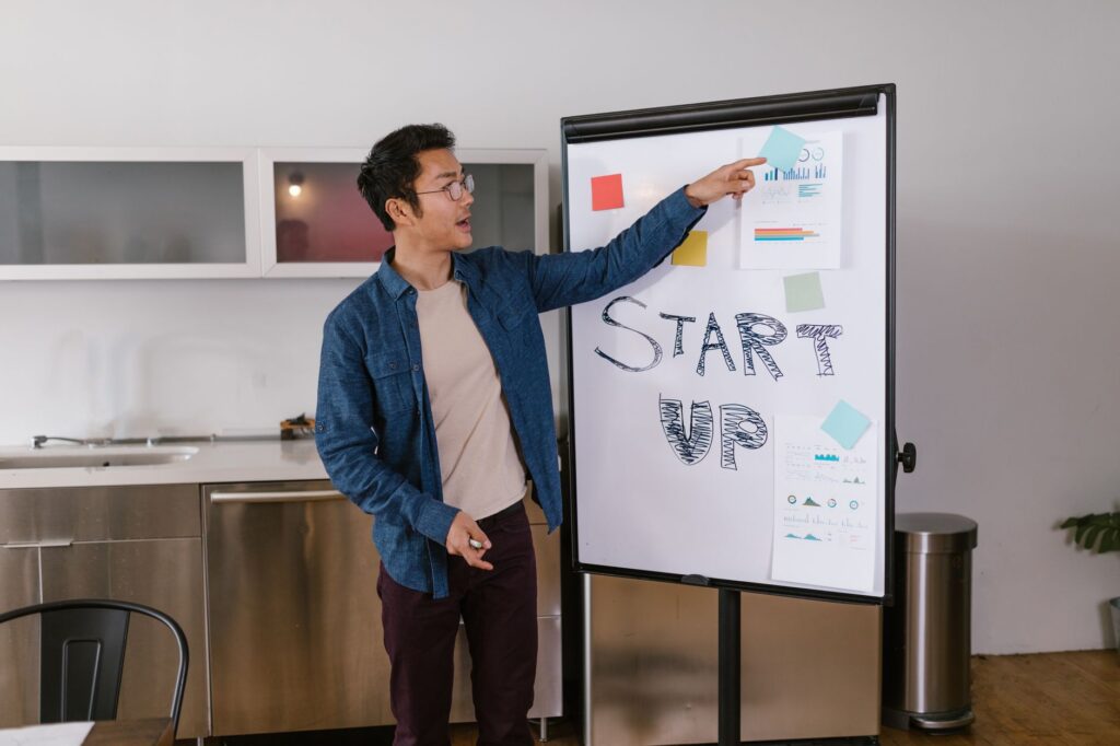 Tome’s AI Pitch Deck Tool Is Circling Pitch’s Startup Base Two founders reviewing a pitch deck presentation on a laptop in a modern office setting