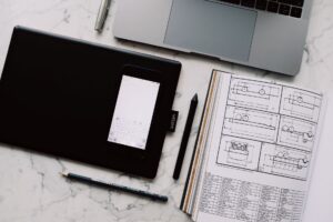 Ideogram’s Design Tools Are Pulling Brands Away from Canva’s AI Suite A designer working at a laptop in a creative workspace, representing digital design tool workflows