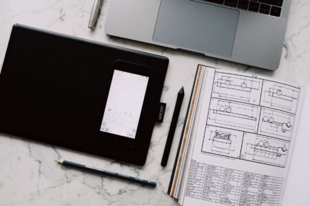 Ideogram’s Design Tools Are Pulling Brands Away from Canva’s AI Suite A designer working at a laptop in a creative workspace, representing digital design tool workflows