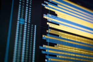 Creative professional working at a video editing workstation with multiple monitors