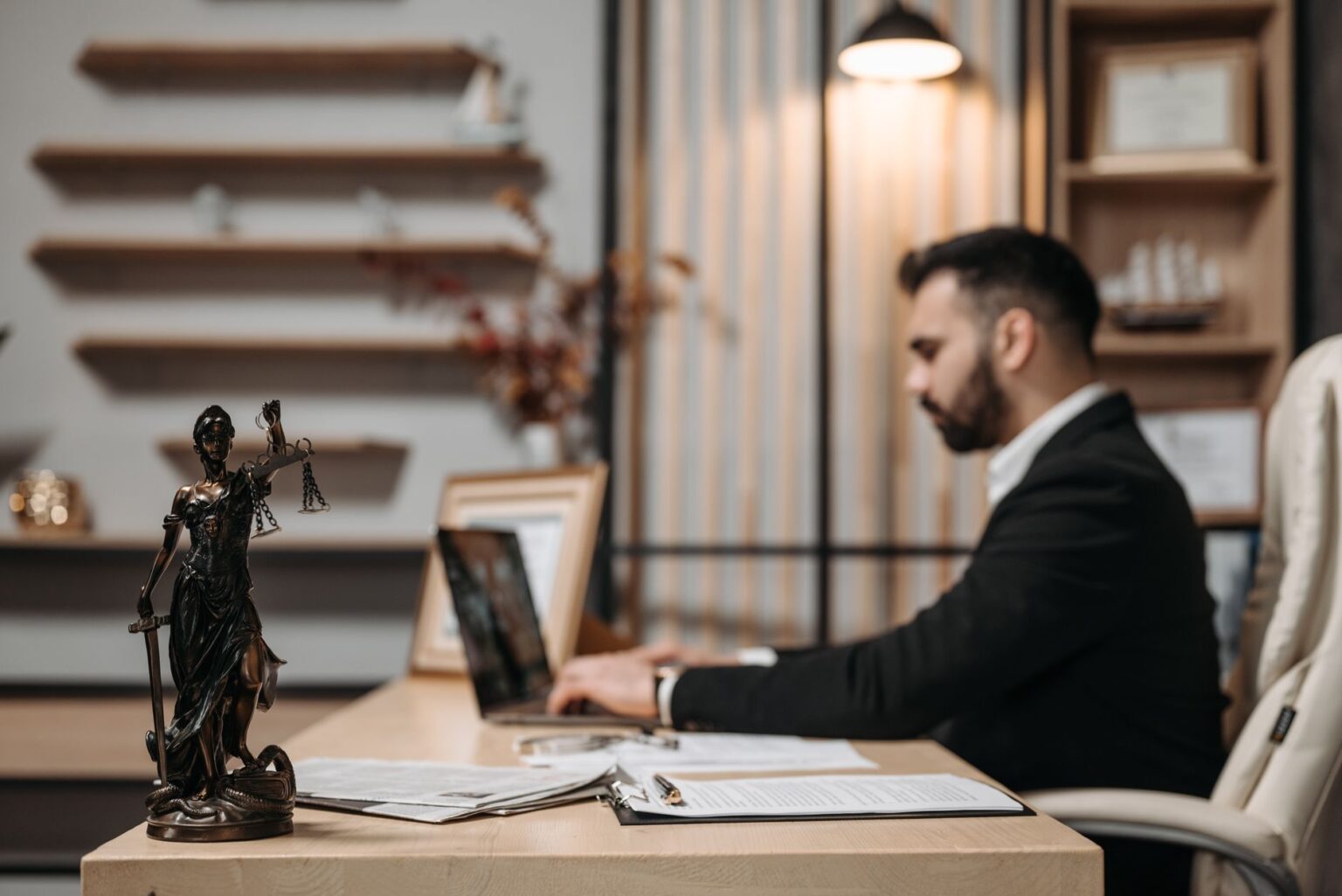 Harvey’s Legal AI Platform Is Squeezing LexisNexis’s Associate Workflow Attorney working at a desk with documents and a laptop in a law office setting