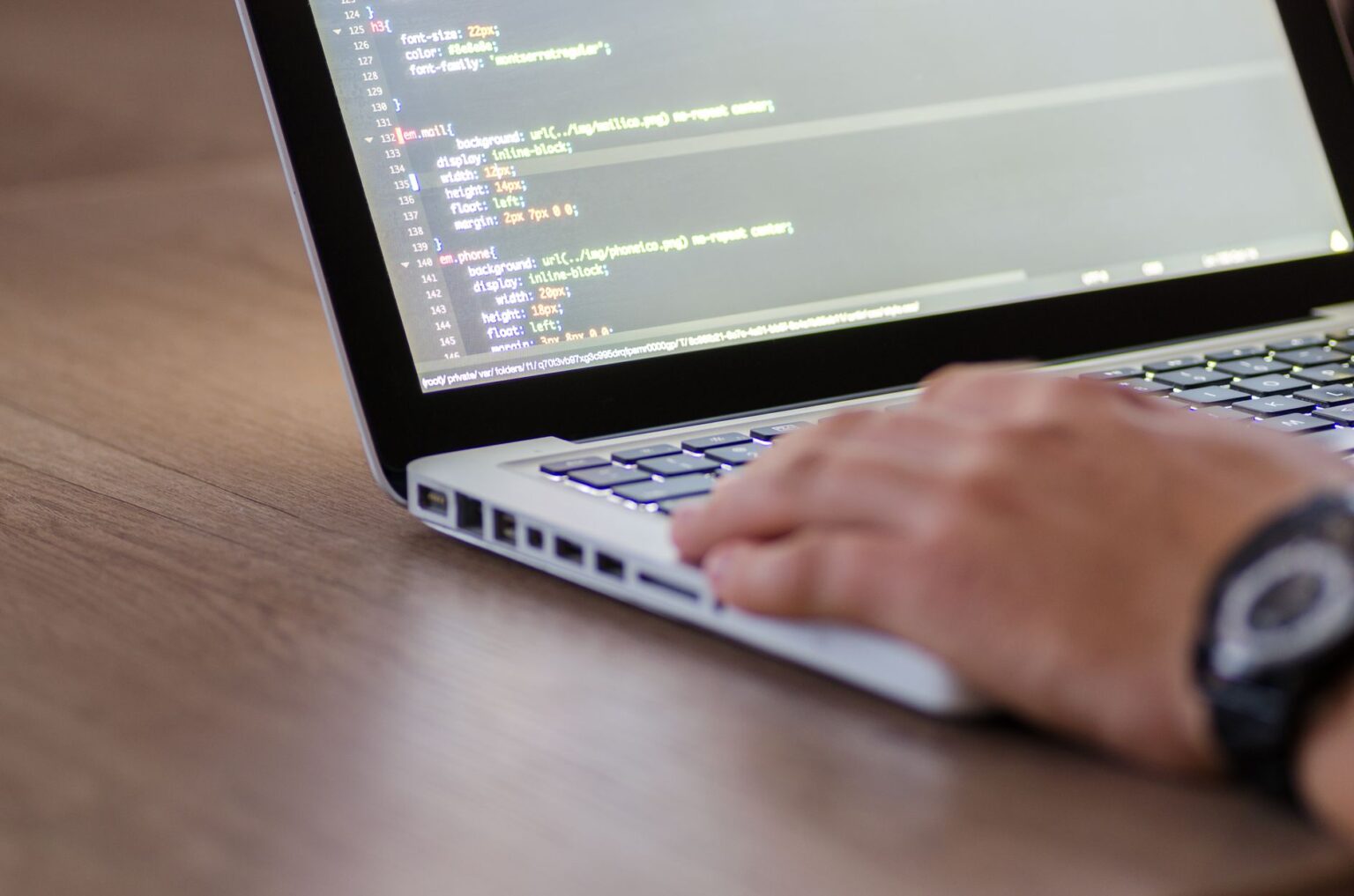 Perplexity’s AI Search API Is Undercutting Algolia’s Developer Base Developer working on a laptop integrating an API into a web application