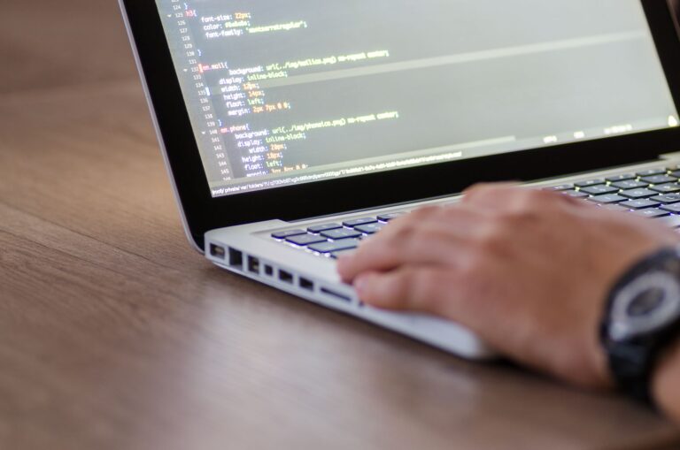 Perplexity’s AI Search API Is Undercutting Algolia’s Developer Base Developer working on a laptop integrating an API into a web application