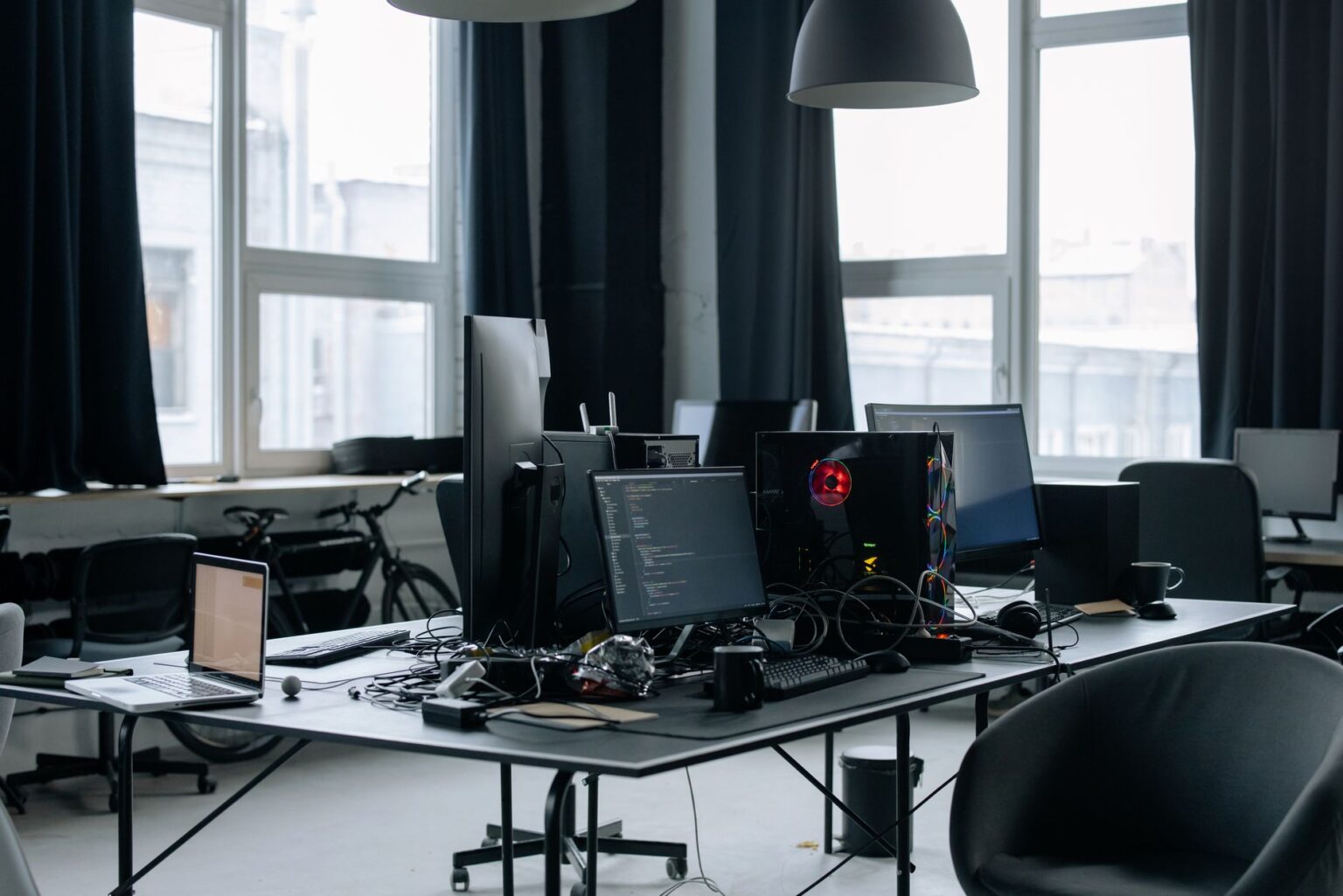 Linear’s Project Management Push Is Cornering Jira’s Developer Base Developer working at a dual-monitor desk with code on screen
