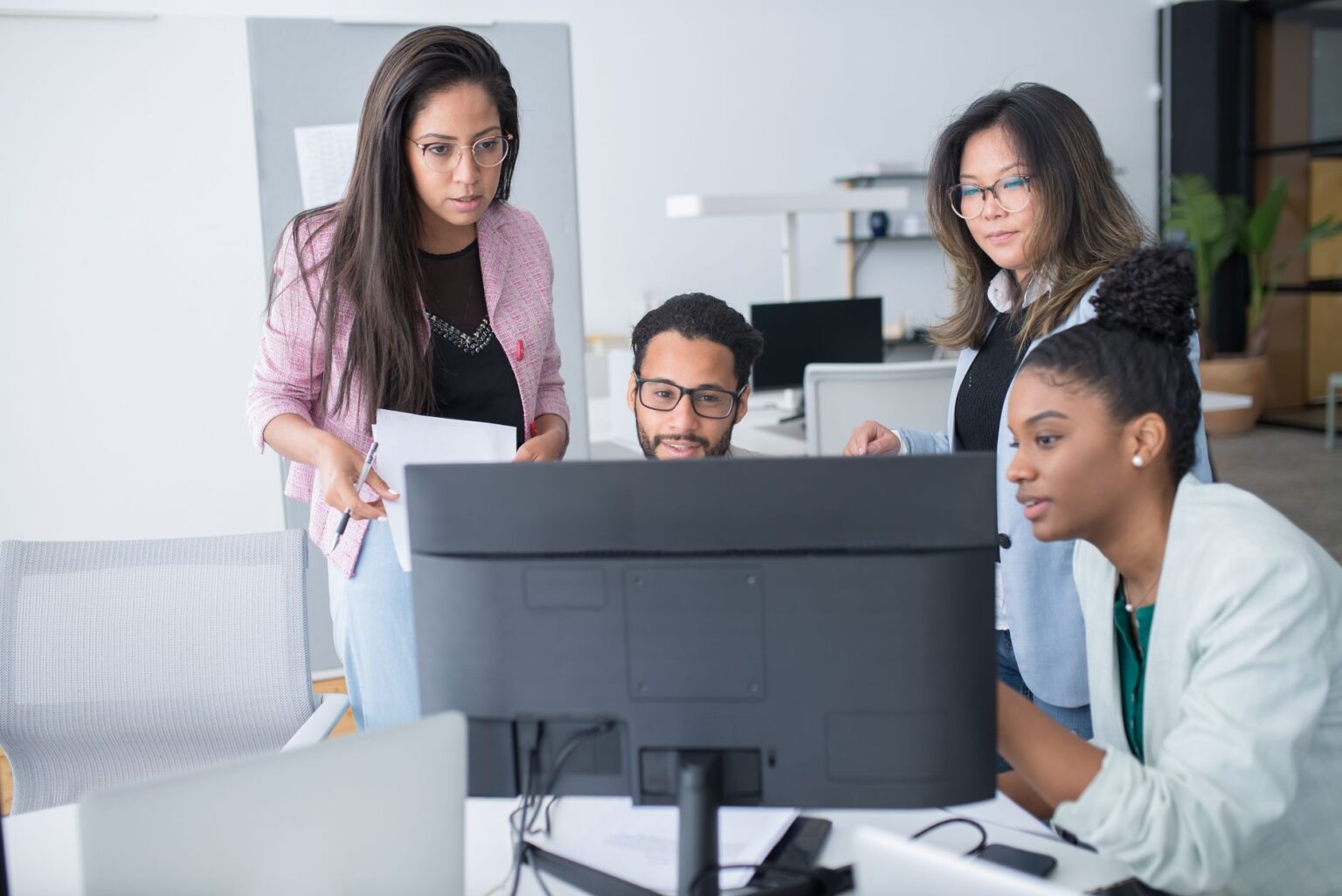 Dust’s Enterprise AI Platform Is Peeling Clients Away from Microsoft Copilot Enterprise team collaborating around screens in a modern office environment