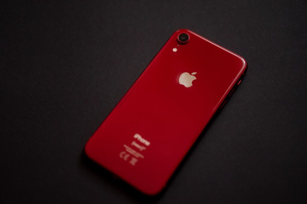Person using a smartphone to photograph a product on a clean surface for e-commerce listing