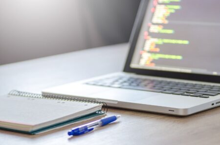 Analyst working on a collaborative data notebook on a laptop screen