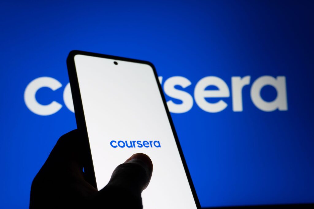Speak’s Language App Is Quietly Eating Duolingo’s Paying Users Person using a language learning app on a smartphone at a desk