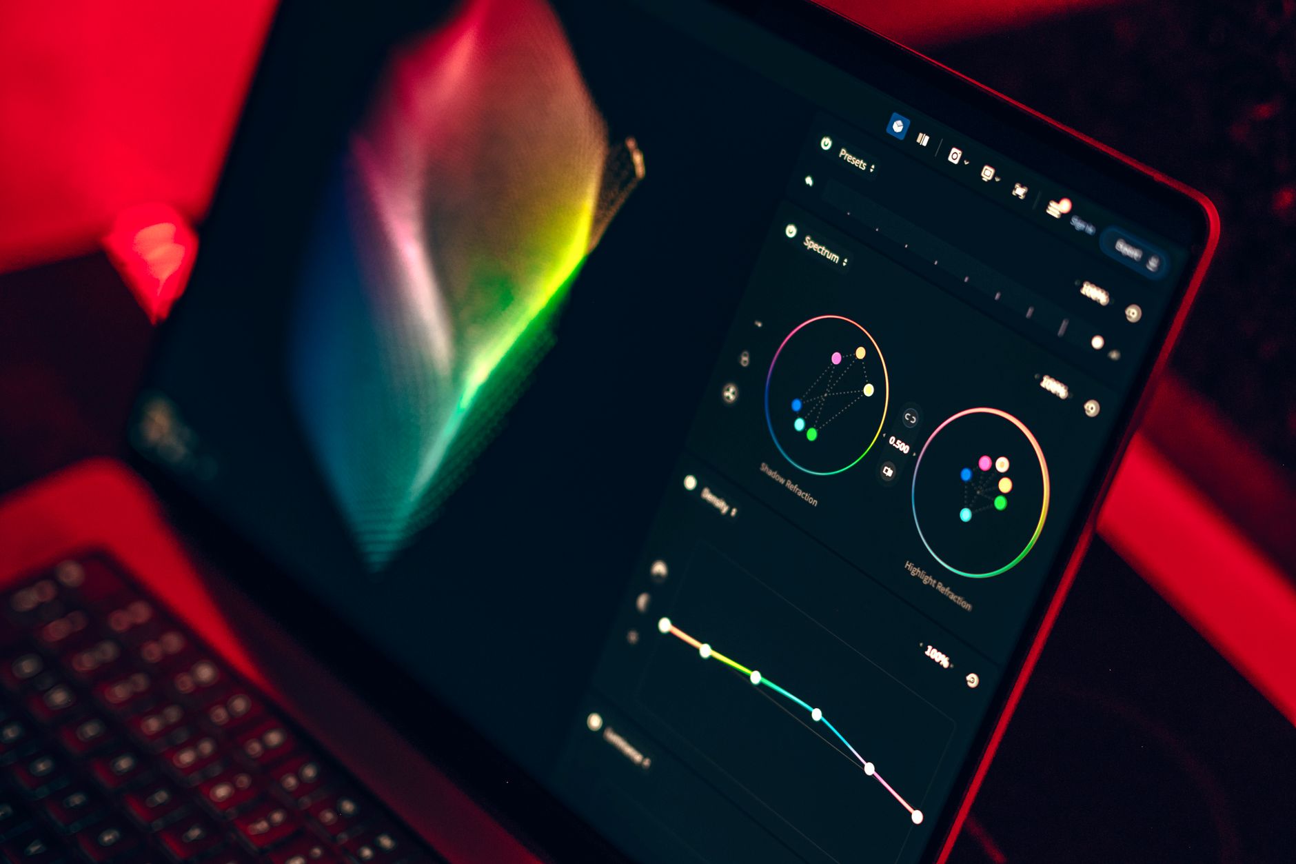 Motion designer reviewing video content on a laptop screen in a modern workspace