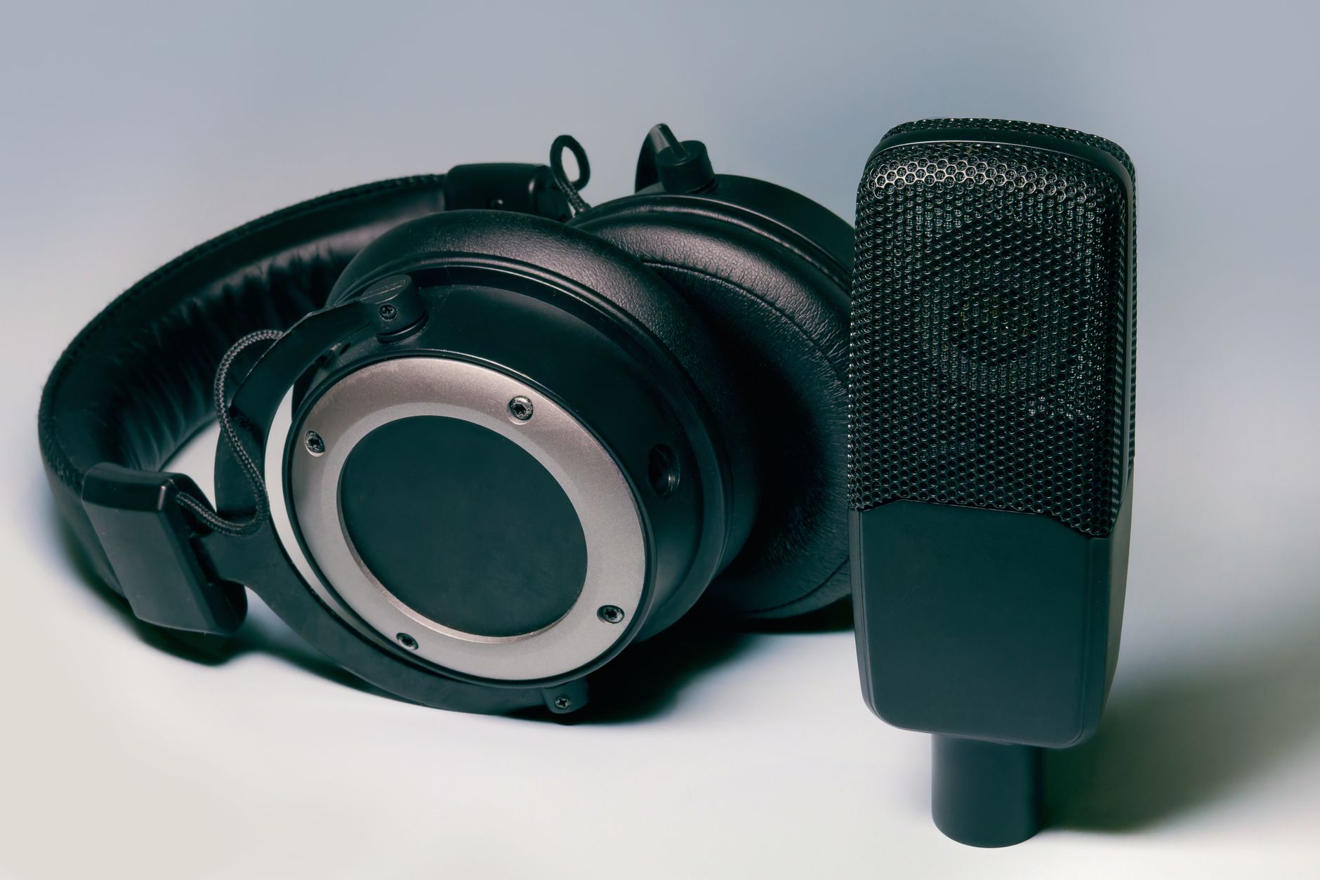 Close-up of headphones resting on an audio mixing board in a recording environment