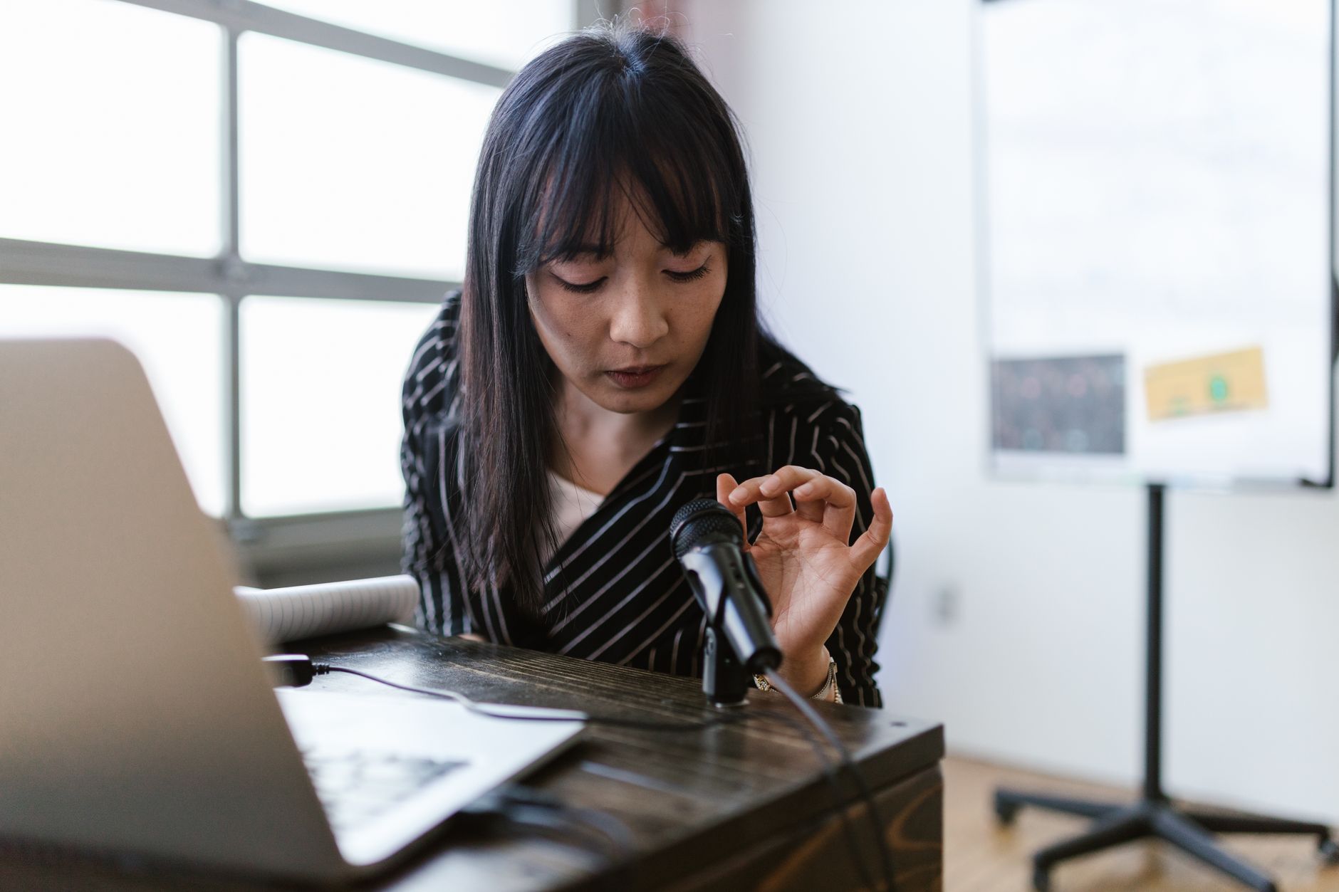 Young woman speaking into a phone practicing a foreign language