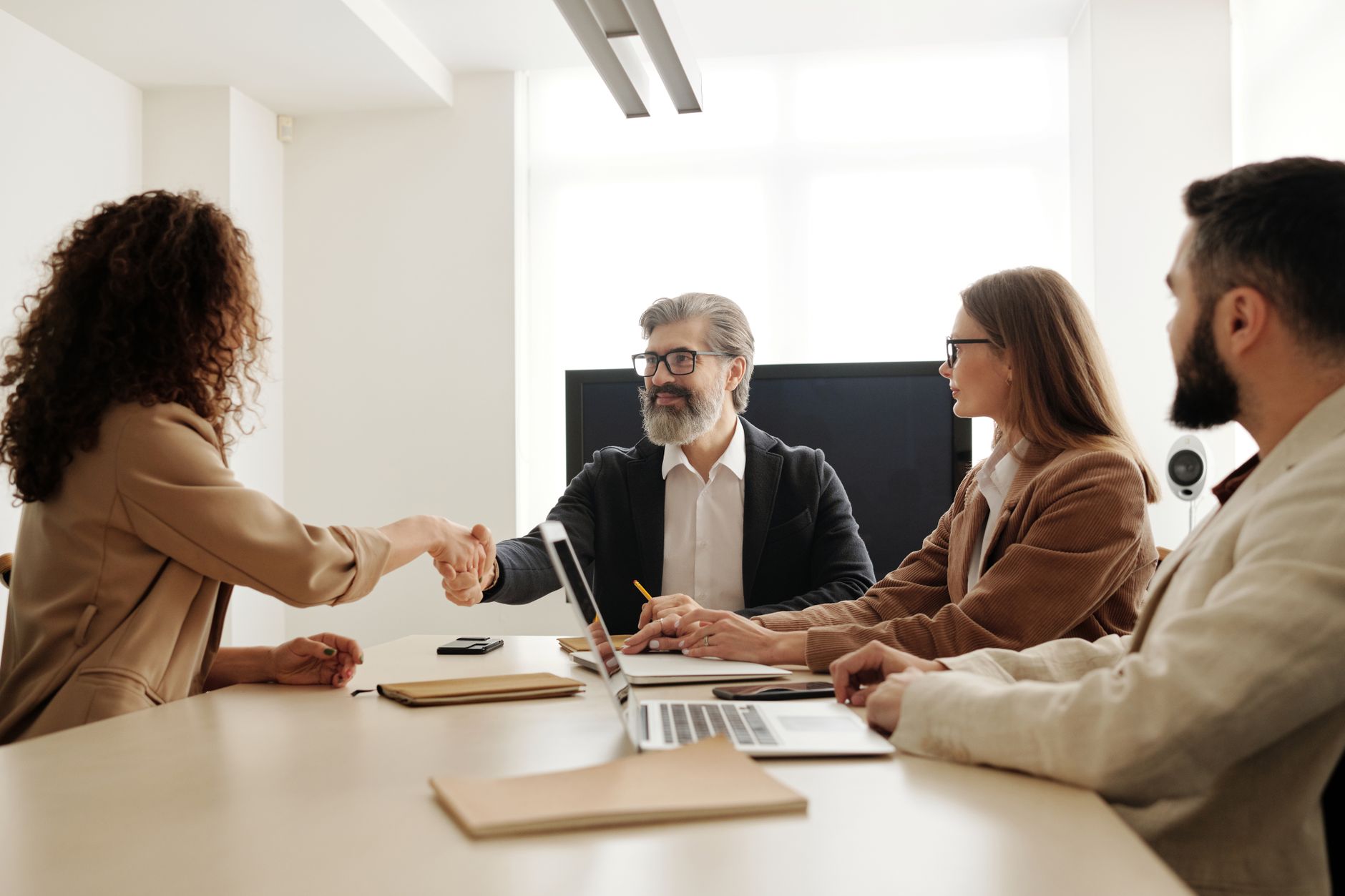 Two professionals reviewing candidate profiles on a screen during an enterprise hiring evaluation