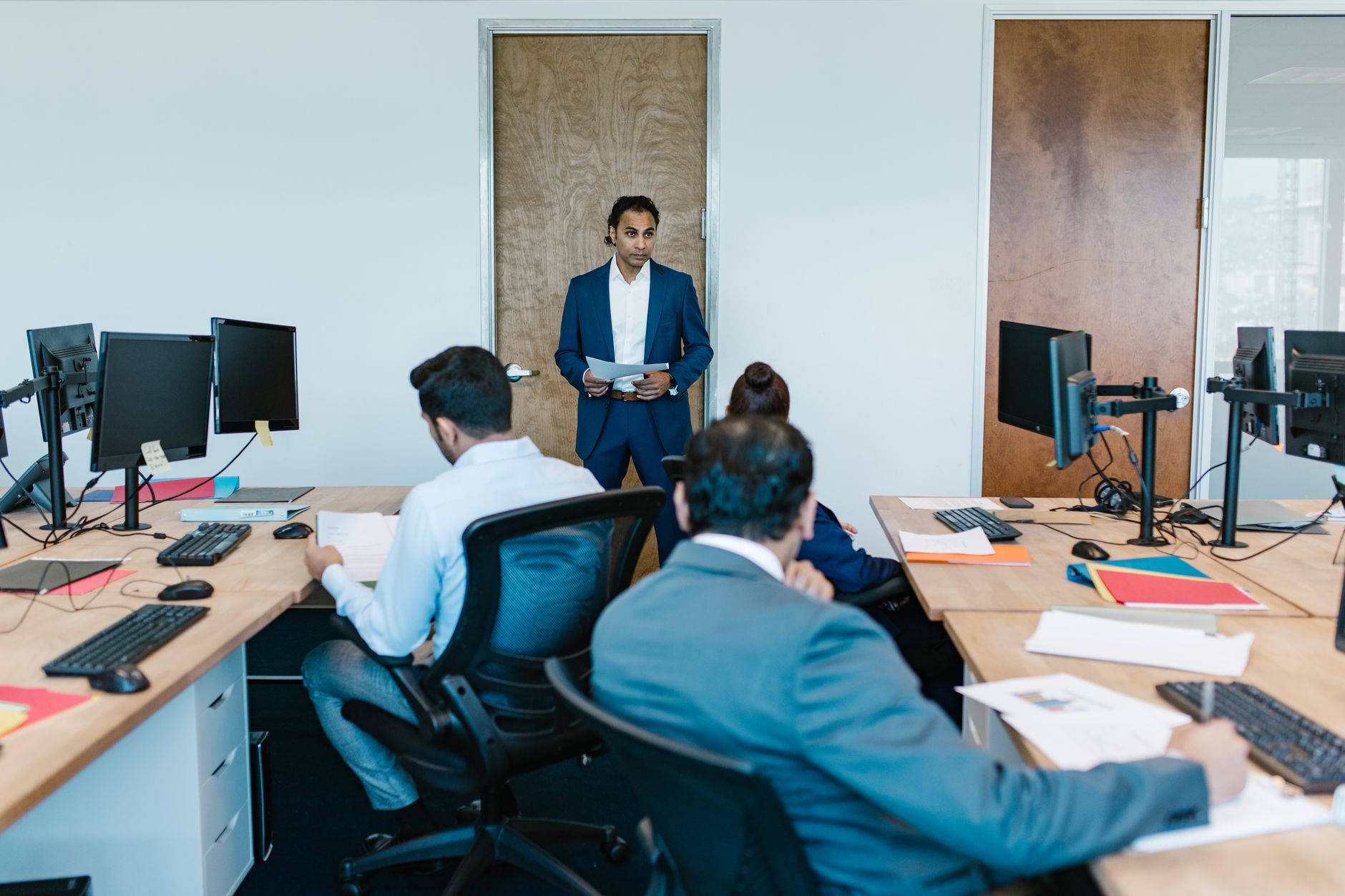 Team of professionals working in an open office environment representing international workforce management
