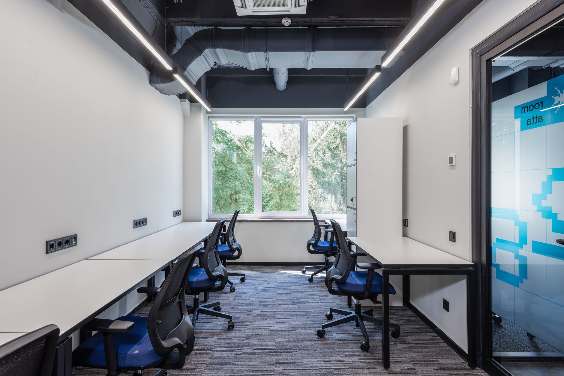 Modern technology office interior with screens and team workspace