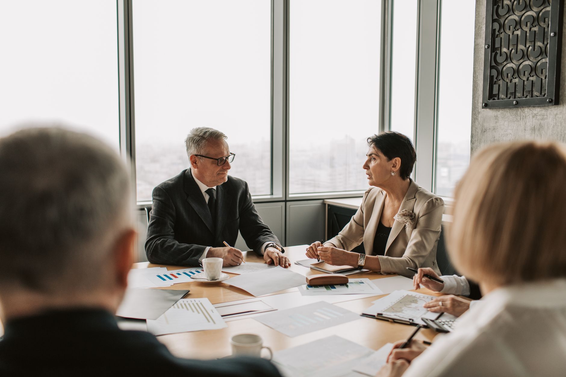 Corporate legal team meeting in a boardroom discussing technology strategy