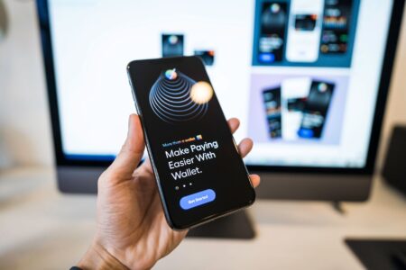 Cleo’s Finance App Is Quietly Eating Chime’s Gen Z Base Person using a mobile finance app on a smartphone