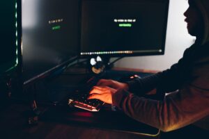 Sardine’s Fraud API Is Quietly Undercutting Stripe Radar’s Risk Base A developer reviewing fraud detection data on multiple screens in a tech office environment