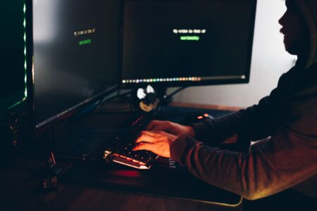 Sardine’s Fraud API Is Quietly Undercutting Stripe Radar’s Risk Base A developer reviewing fraud detection data on multiple screens in a tech office environment