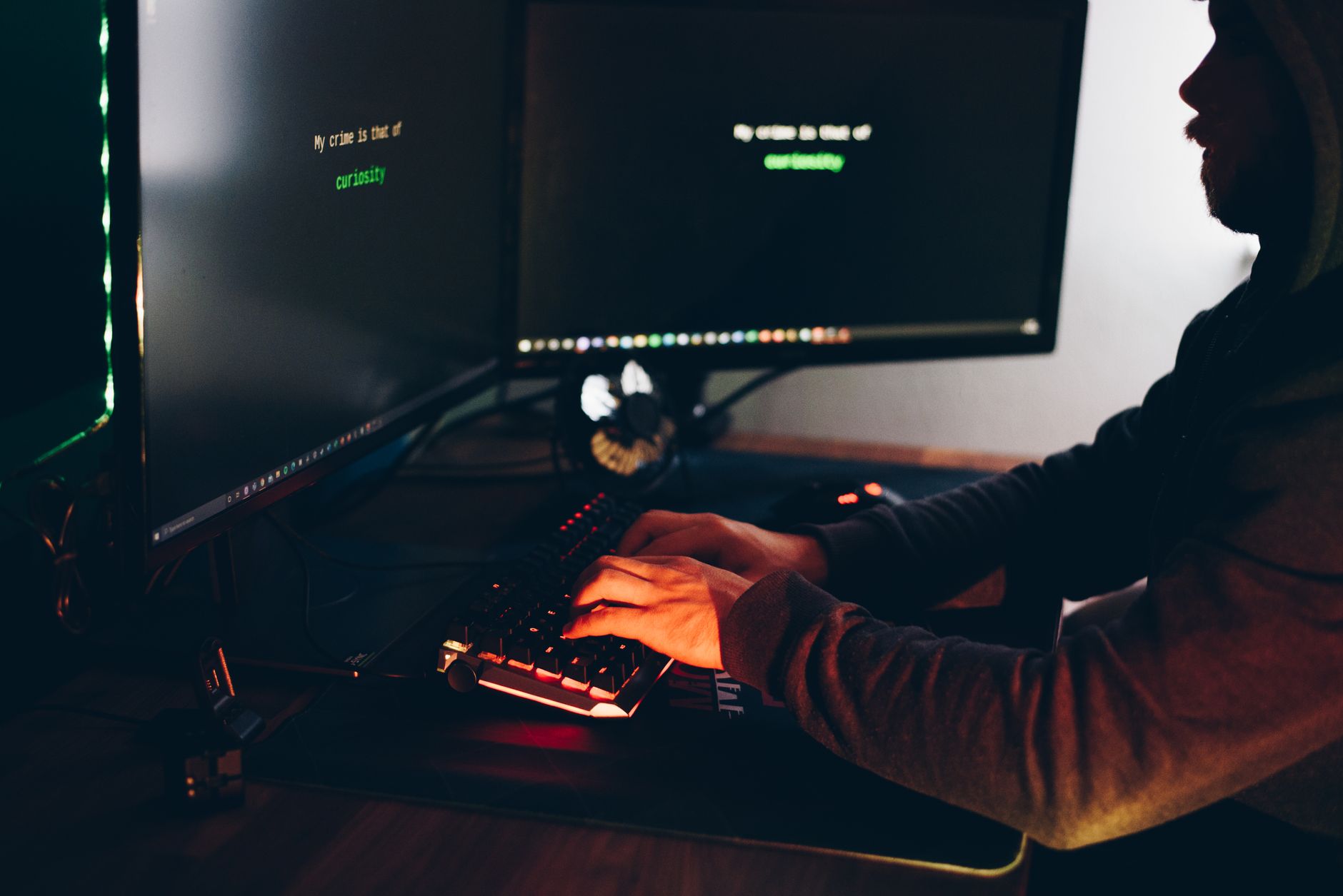 A developer reviewing fraud detection data on multiple screens in a tech office environment