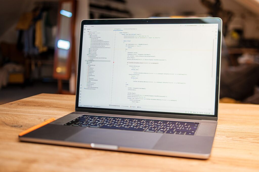 Linear’s Project Management Push Is Cornering Jira’s Developer Base Developer working at a desk with multiple monitors showing code and project management tools