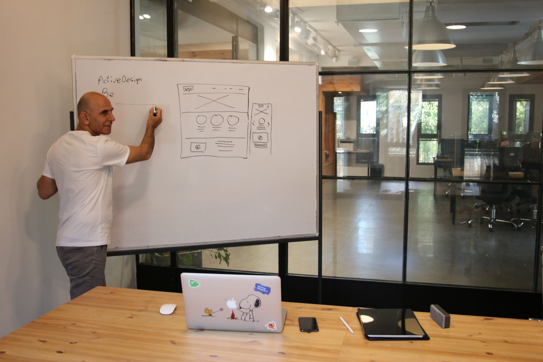 A person working on a presentation at a modern desk with a laptop and monitor