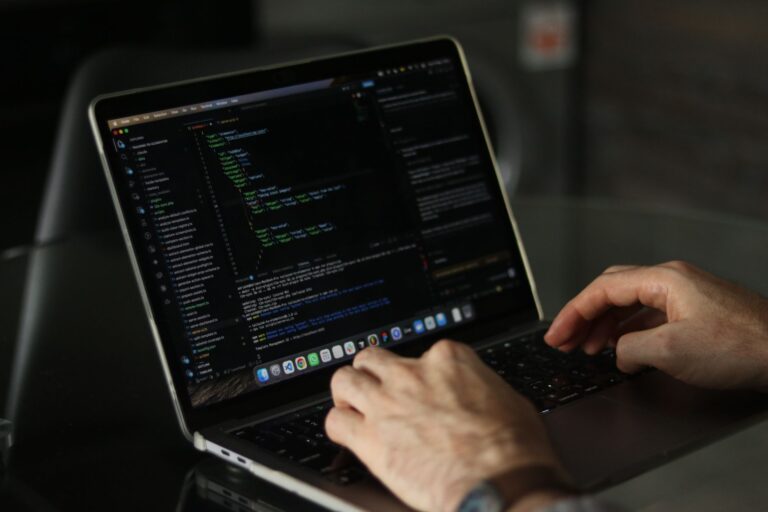 Vercel’s AI SDK Is Quietly Pulling Workloads Away from LangChain Developer writing code on a laptop screen in a modern workspace