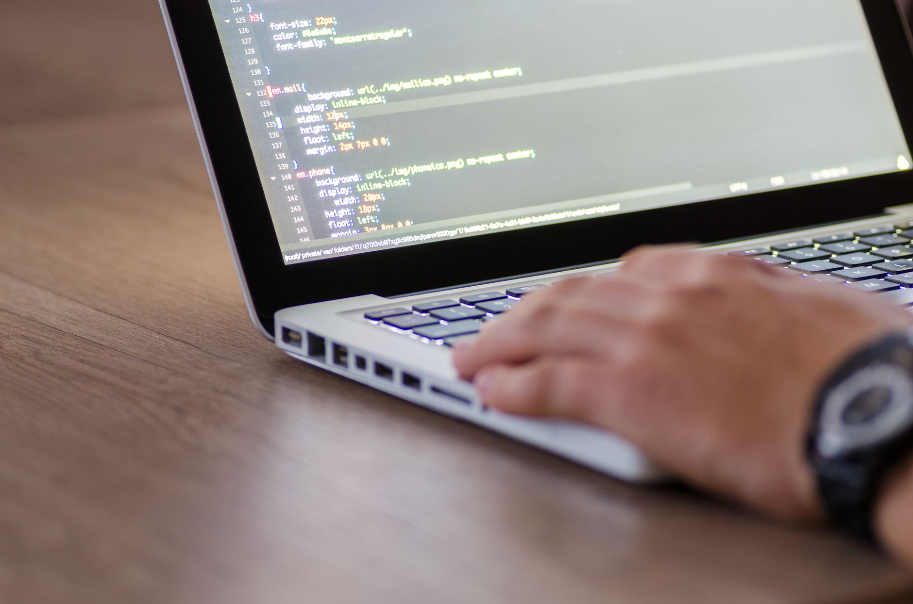 Developer working on a laptop building a web application