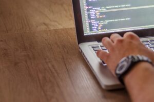 Vercel’s v0 Is Quietly Pulling Design Budgets from Figma’s Dev Base Developer working on a laptop writing frontend code for a web application