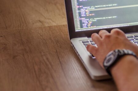Vercel’s v0 Is Quietly Pulling Design Budgets from Figma’s Dev Base Developer working on a laptop writing frontend code for a web application