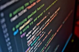 Dify’s Open-Source AI Workflow Layer Is Crowding Flowise’s Builder Base Developer working on an AI workflow interface on a computer screen