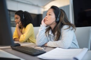 Decagon’s AI Support Agent Is Peeling Clients Away from Salesforce Service Cloud Customer support representative at a modern office desk using a computer