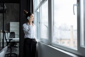 Bland AI’s Voice Agent Platform Is Squeezing Twilio’s Programmable Voice Base A professional on a phone call at a modern office desk representing AI voice technology