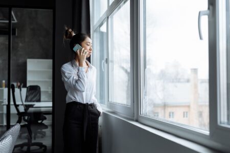 Bland AI’s Voice Agent Platform Is Squeezing Twilio’s Programmable Voice Base A professional on a phone call at a modern office desk representing AI voice technology