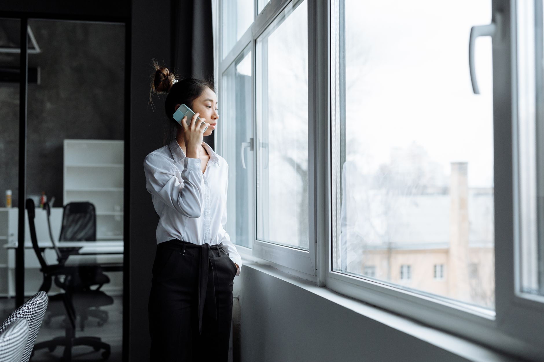 A professional on a phone call at a modern office desk representing AI voice technology