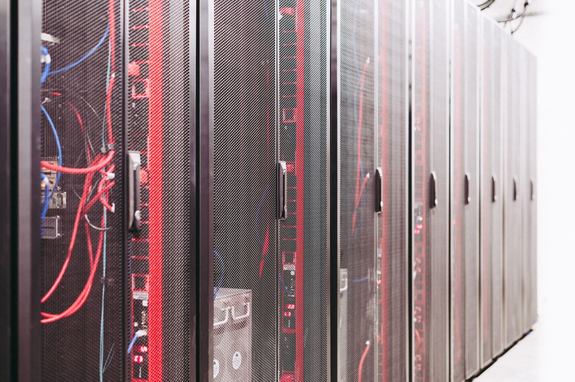 Server racks in a data center representing cloud infrastructure and backend systems