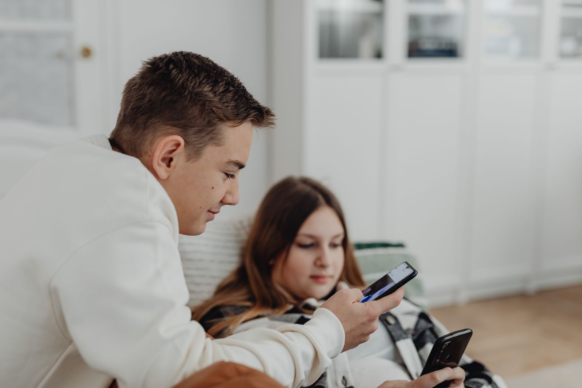 Young adult scrolling through a financial app on their phone