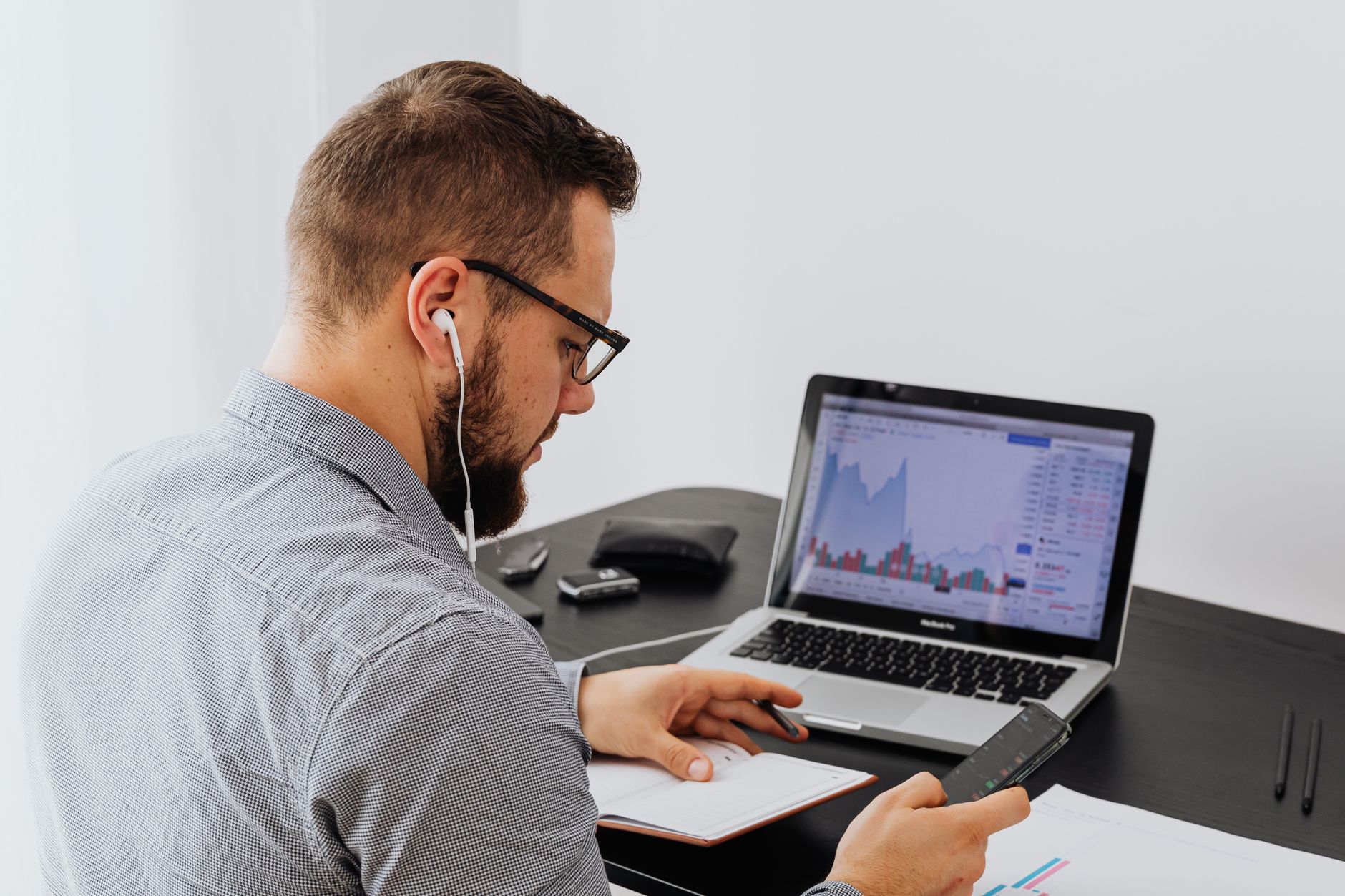 Data analyst reviewing reports on a computer screen in an office setting