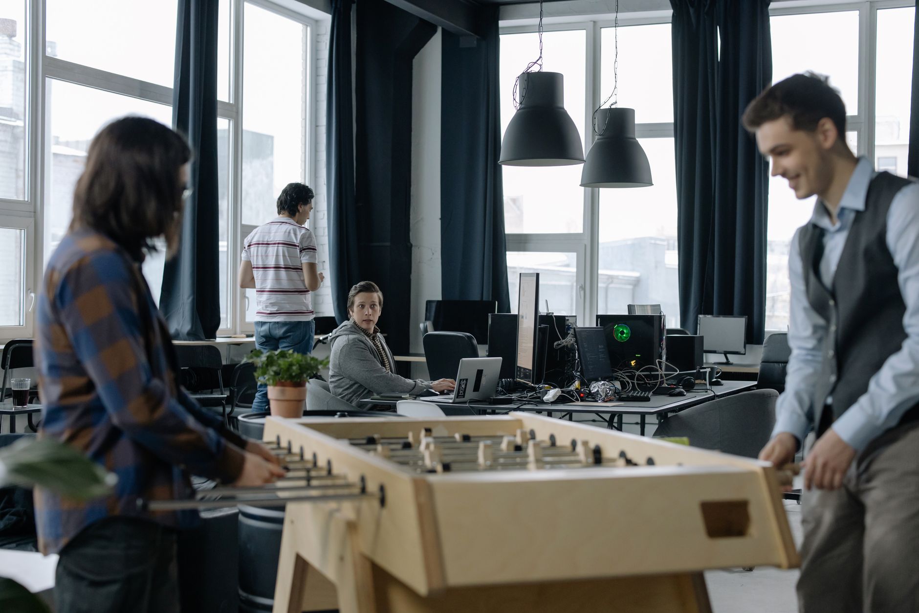 Open plan startup office with engineers working at standing desks