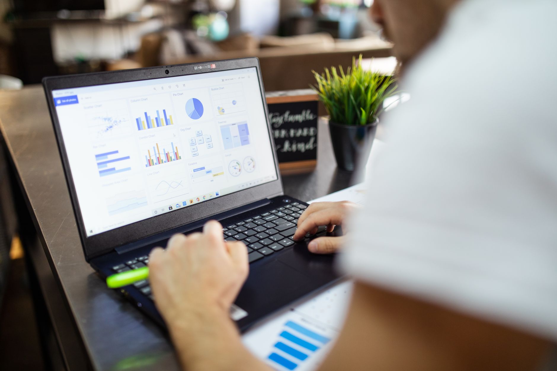 Person working on a laptop with digital planning tools open on screen