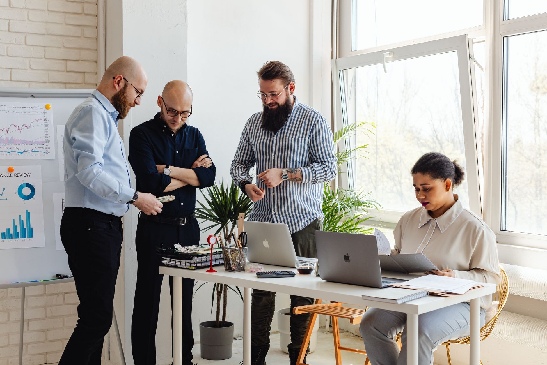 A small startup team collaborating around a table, representing no-code tool adoption in early-stage companies