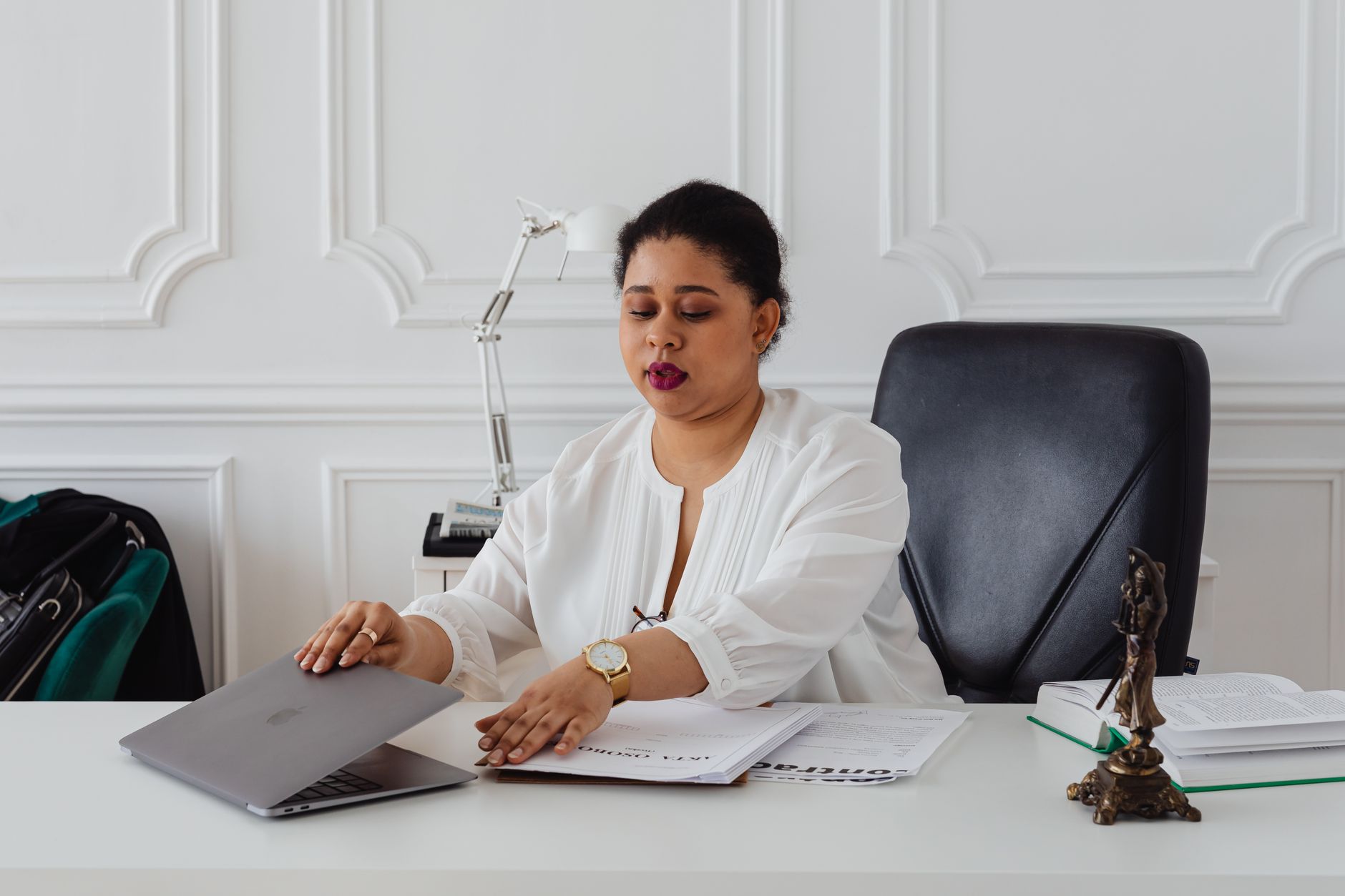 Lawyer reviewing documents on a laptop in a modern law firm office
